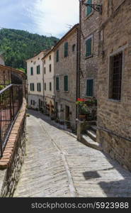 Narrow old street with flowers in Italy