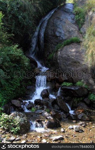 Narrow river and small waterfall in Nepal