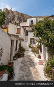 Narrow steps in ancient neighborhood of Anafiotika in Athens by the Acropolis. Narrow street in ancient residential district of Anafiotika in Athens Greece