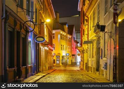 Narrow street illuminated of Old Town at night, Riga, Latvia
