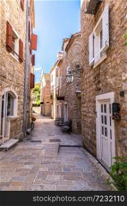Narrow street in old town in Budva in a beautiful summer day, Montenegro