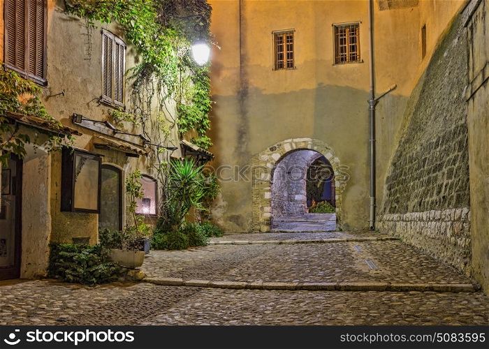 Narrow street in old town in France at night