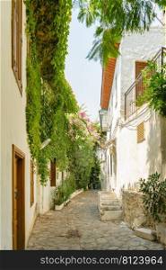 Narrow street in old town of Marmaris, Turkey . Beautiful scenic old ancient white houses with flowers. Popular tourist vacation destination. Narrow street in old town of Marmaris, Turkey . Beautiful scenic old ancient white houses with flowers.