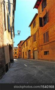 Narrow street in the medieval city of Siena in Tuscany