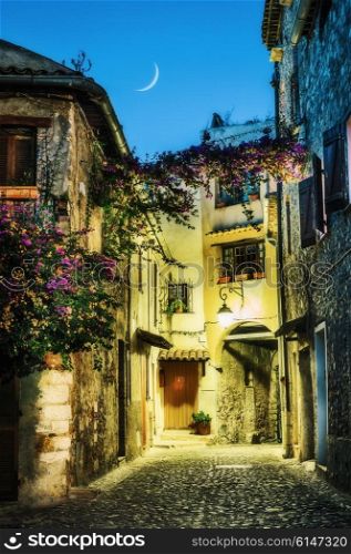 Narrow street in the old town in France. Night view
