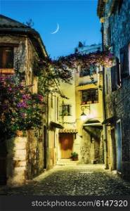 Narrow street in the old town in France. Night view