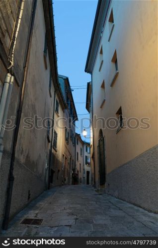 Narrow street in the old town in Italy at night