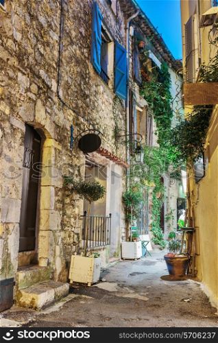 Narrow street with flowers in the old town Mougins in France. Night view