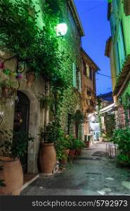 Narrow street with flowers in the old town Mougins in France. Night view
