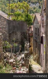 Narrow street with rustic houses and homes in the coastal town of Novigrad in Croatia. Rustic homes in Croatian town of Novigrad in Istria County