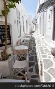 Narrow street with traditional white houses in Parikia, Paros, Greece