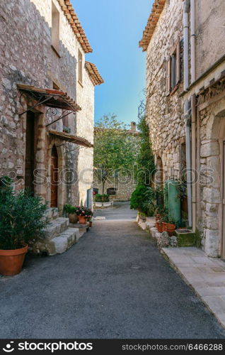 Narrow streets with flowers in the old village Gourdon, France