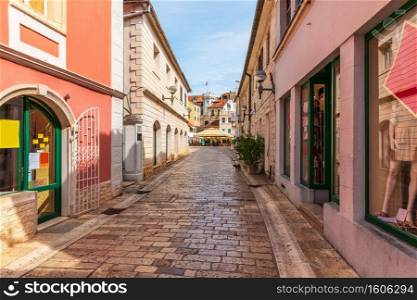 Narrow traditional European Street near the Center square, clock-tower and the old town gate of Herceg Novi, Montenegro.. Narrow traditional European Street near the Center square, clock-tower and the old town gate of Herceg Novi, Montenegro