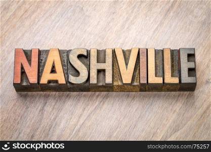 Nashville word abstract in vintage letterpress wood type against grained wooden background