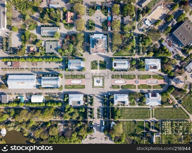 National Exhibition Center in Kiev. View of old buildings and squares with green islands of trees and grass. Photo from the drone. view of the buildings and symmetrical square of the National Exhibition Center in Kiev