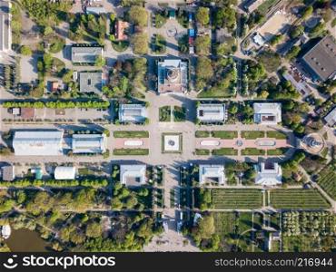 National Exhibition Center in Kiev. View of old buildings and squares with green islands of trees and grass. Photo from the drone. view of the buildings and symmetrical square of the National Exhibition Center in Kiev