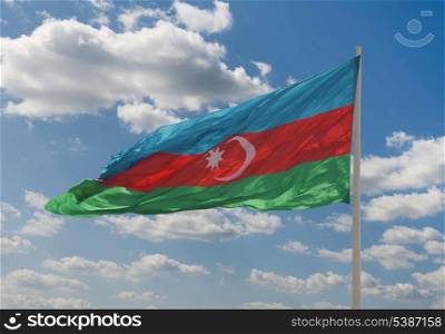 National flag of Azerbaijan against blue sky