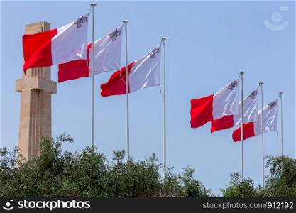 National flag of Malta against the blue sky in Valletta.. Malta. National Flag.