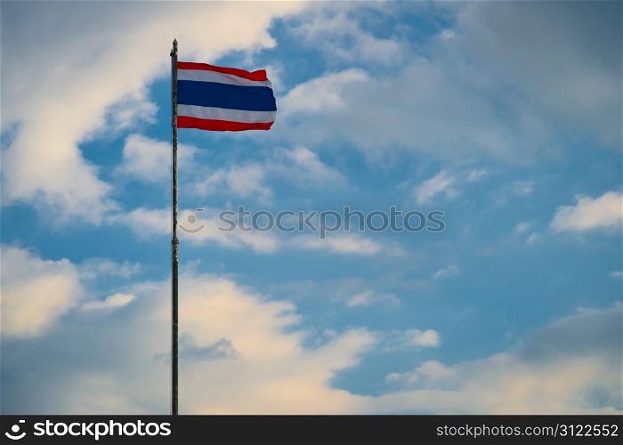 National flag of Thailand on the cloudy sky background