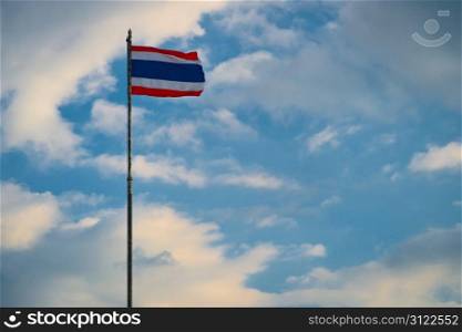 National flag of Thailand on the cloudy sky background