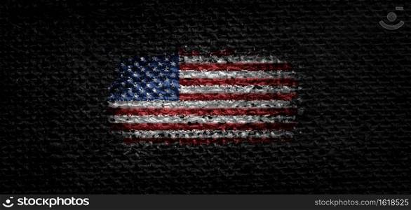 National flag of the United States on dark fabric.. National flag of the United States on dark fabric
