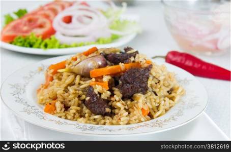 National pilau rice with beef served on a round plate. Asian food