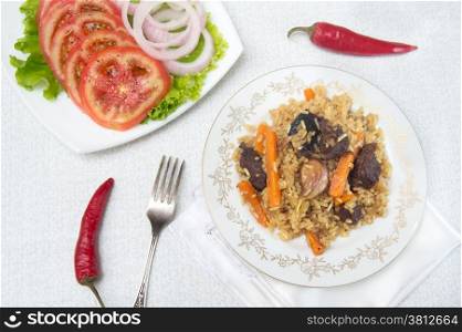 National pilau rice with beef served on a round plate. Asian food