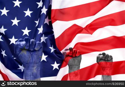 national textile flag of United States of America, surface in waves. Independence Day Background, against the background of the flag a hand is raised up and clenched into a fist