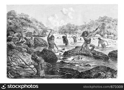 Natives Spearing Fish Trapped in the Rocks in Oiapoque, Brazil, drawing by Riou from a sketch by Dr. Crevaux, vintage engraved illustration. Le Tour du Monde, Travel Journal, 1880