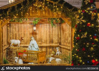 Nativity scene with Holy family of Joseph, Mary, baby Jesus Christ and sheep, holiday decorations in the Old Town in the magical city of Prague at night, Czech Republic