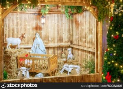 Nativity scene with the holy family of Joseph, Mary, baby Jesus and sheep, holiday decorations in the Old City at night. Prague. Czech Republic.