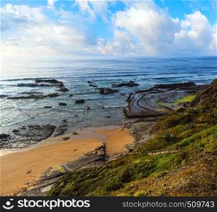 Natural amphitheater (stony curves) on Carriagem beach at low tide (Aljezur, Algarve, Portugal).