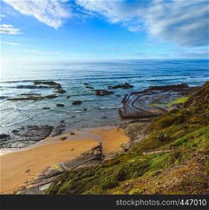 Natural amphitheater (stony curves) on Carriagem beach at morning low tide, Aljezur, Algarve, Portugal