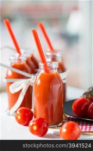 Natural and fresh tomato juice in small bottles