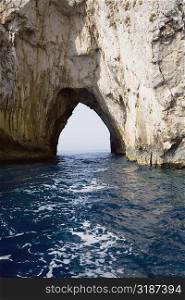 Natural arch in a rock formation, Faraglioni Rocks, Capri, Campania, Italy