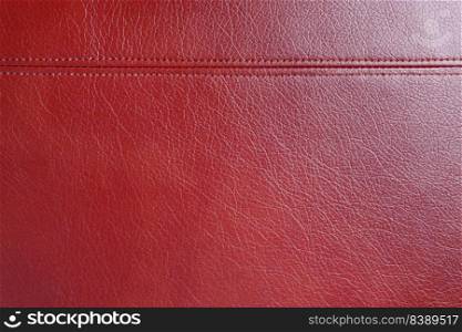 Natural, artificial red leather texture background with decorative seam. Material for sport items, clothes, furnitre and interior design. ecological friendly leatherette.. Red leather, leatherette texture background wtih decorative stich