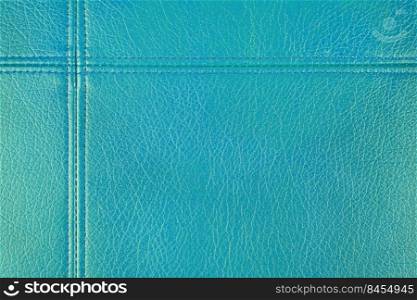 Natural, artificial turquise leather texture background with decorative seam. Material for sport items, clothes, furnitre and interior design. ecological friendly leatherette.. Turquoise leather, leatherette texture background wtih decorative stich