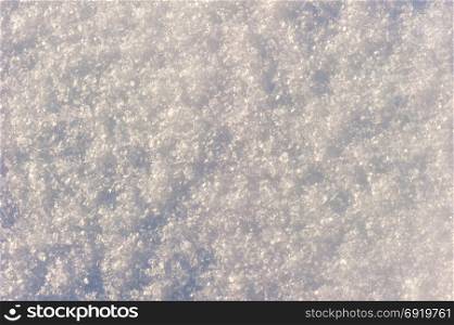natural background - a surface covered with snow in the sun&rsquo;s rays