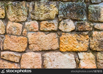 Natural background - large rough stone wall close-up