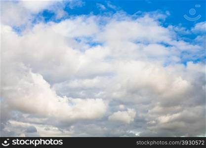 natural background - low dense gray and white autumn clouds in blue sky