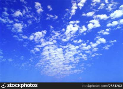 Natural background of bright blue sky with unusual clouds formation