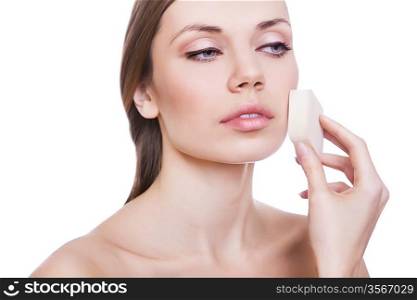 natural beautiful woman with powder sponge on white background