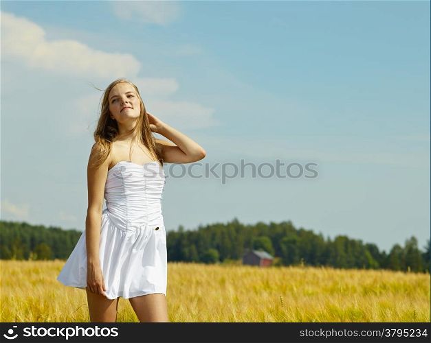 Natural beautiful young woman, rural landscape on background