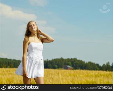 Natural beautiful young woman, rural landscape on background