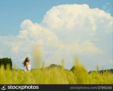 Natural beautiful young woman, rural landscape on background