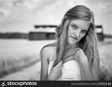 Natural beautiful young woman, rural landscape on background, black and wihite image