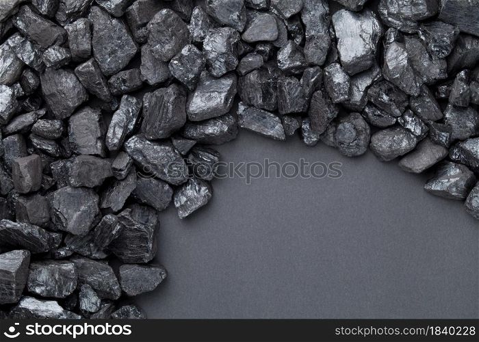 Natural black coals over black background with copy space. Top view. Natural Black Coals Over Black Background