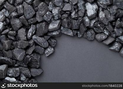 Natural black coals over black background with copy space. Top view. Natural Black Coals Over Black Background