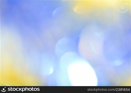 Natural bokeh background with sun rays. Blue sky and white clouds bokeh backdrop. Abstract natural background. Copy space of summer vacation concept.. Abstract bokeh blurred yellow sun and blue sky