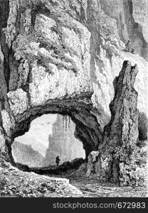 Natural bridge in the mountains, vintage engraved illustration. Le Tour du Monde, Travel Journal, (1872).